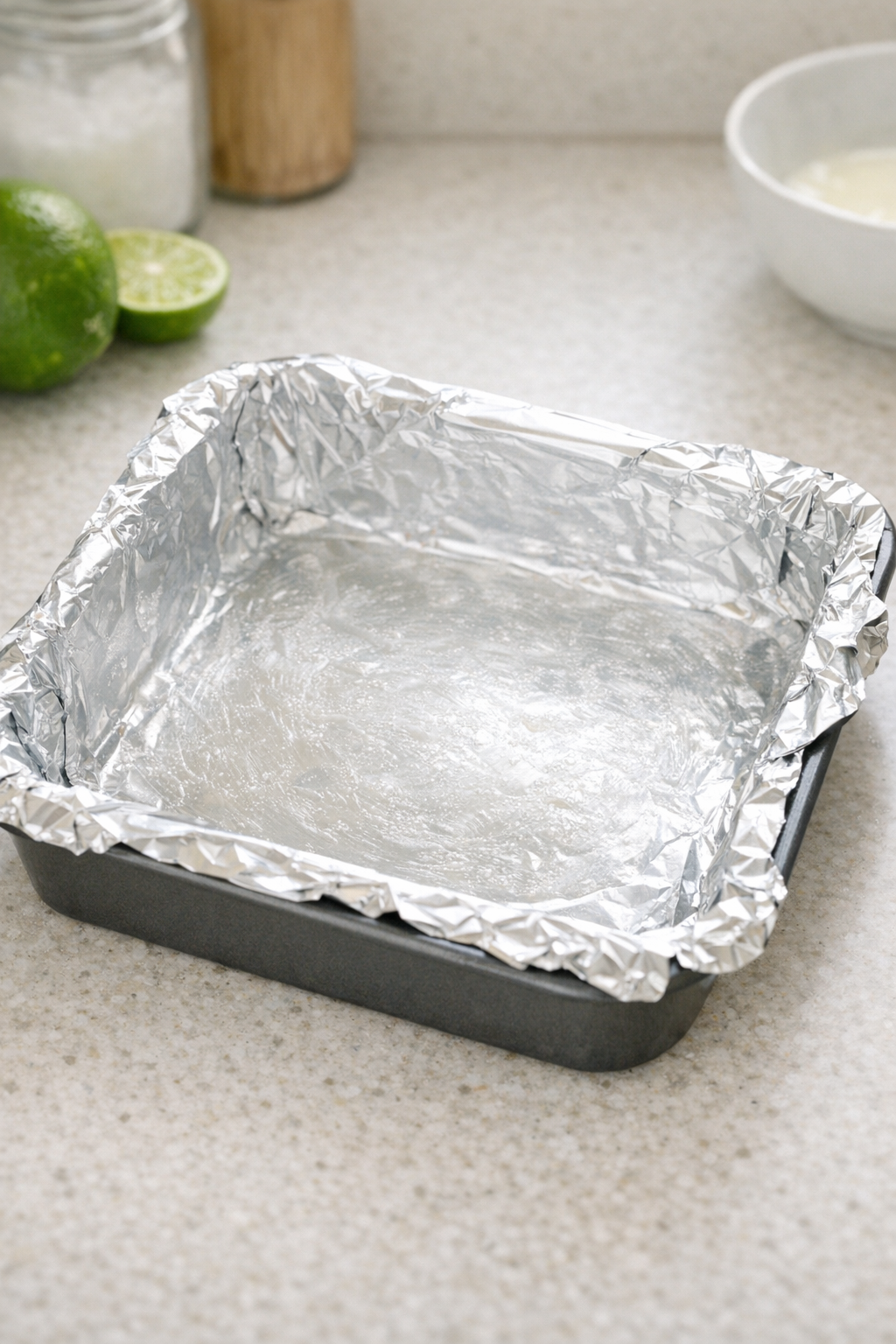 Foil-lined square pan prepared for fudge