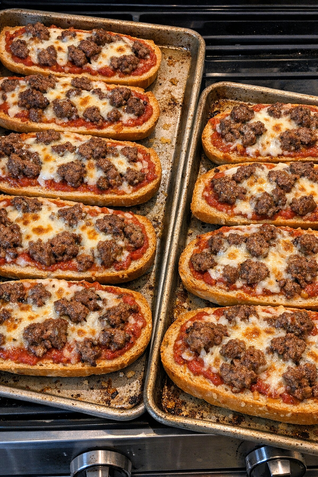 Finished beef french bread pizzas with melted mozzarella
