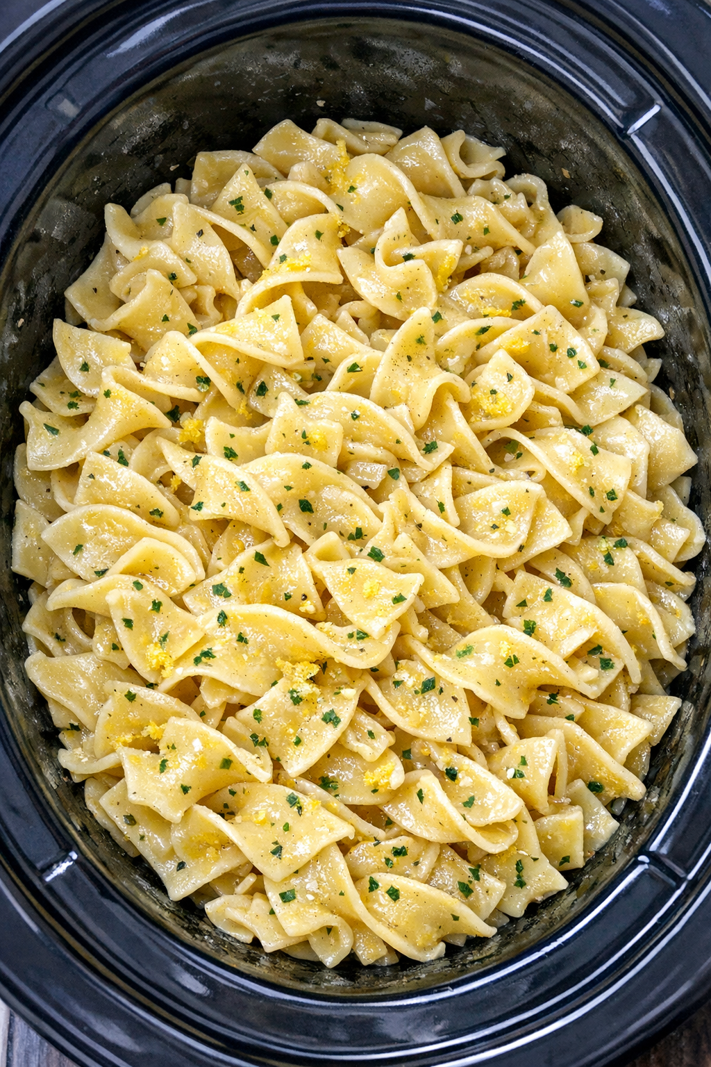 Slow cooker Amish lemon butter noodles in a black slow cooker