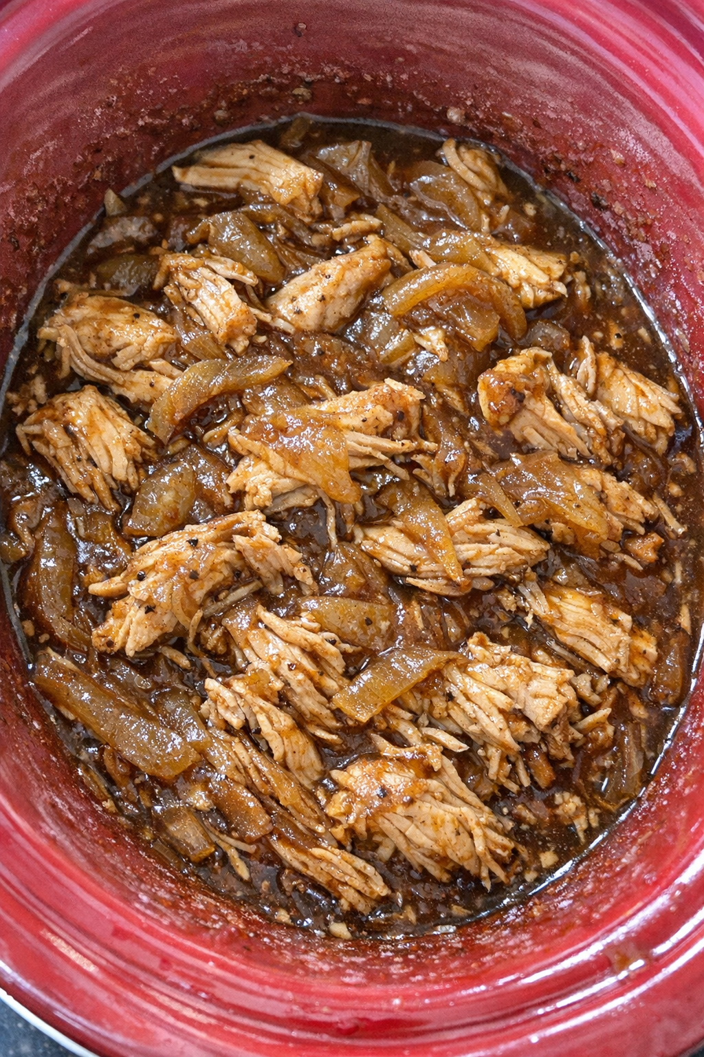 Slow cooker onion soup chicken finished in a red slow cooker