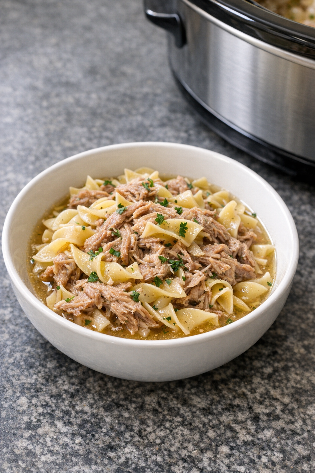 Finished plated chicken broth pork pasta