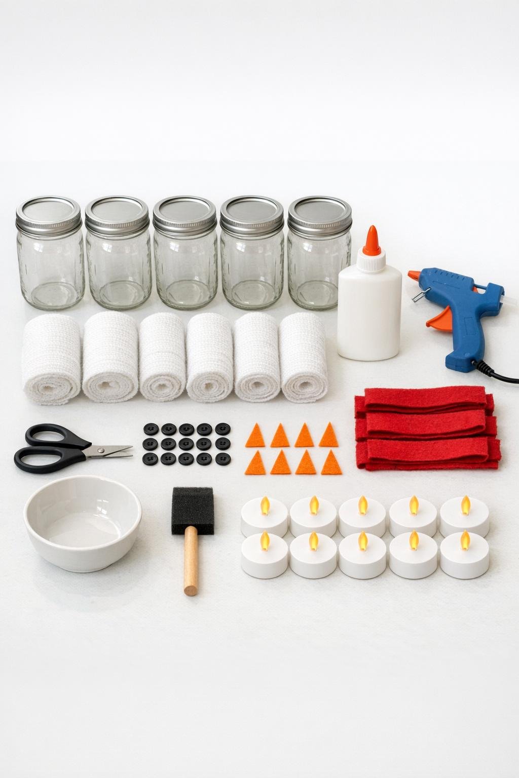 Snowman jar luminary materials laid out on a table