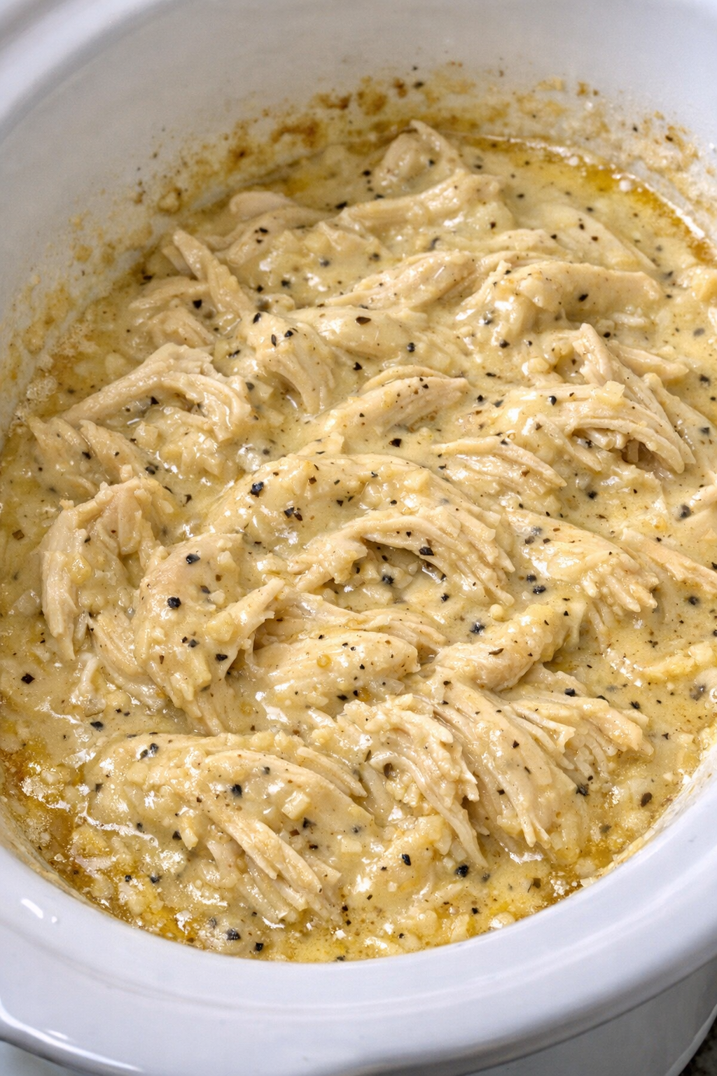 Creamy Dijon chicken in a white slow cooker