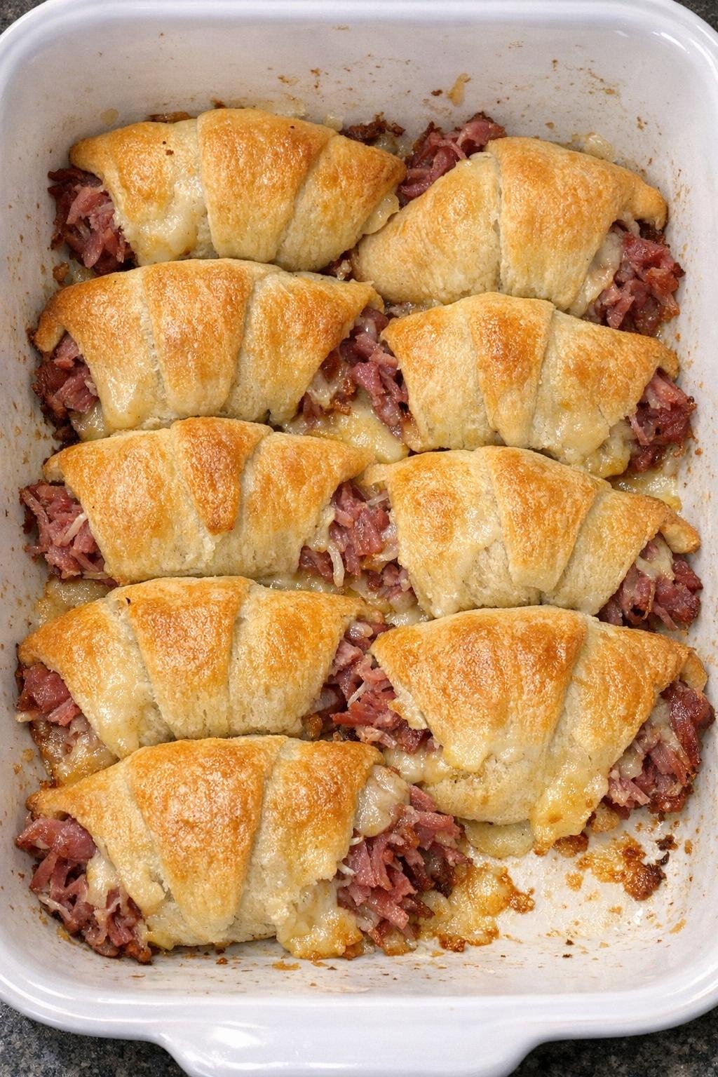 Crispy golden crescent dough envelopes stuffed with shredded corned beef and melted aged gouda cheese