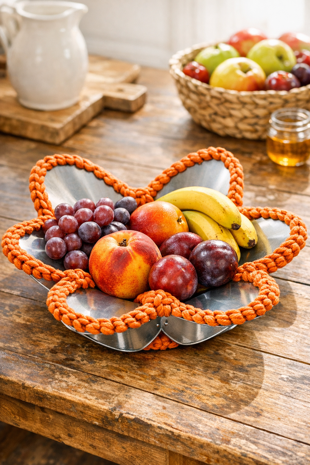 Finished sunset orange crocheted fruit bowl made from ceiling fan blades
