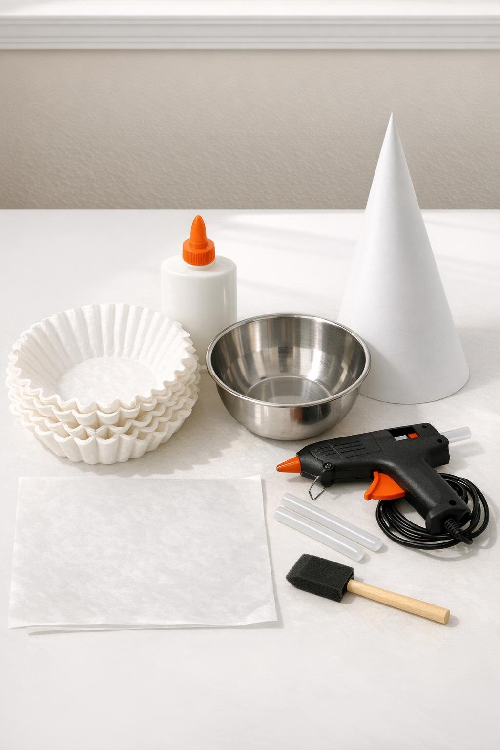Materials for the coffee filter glue craft laid out on a table
