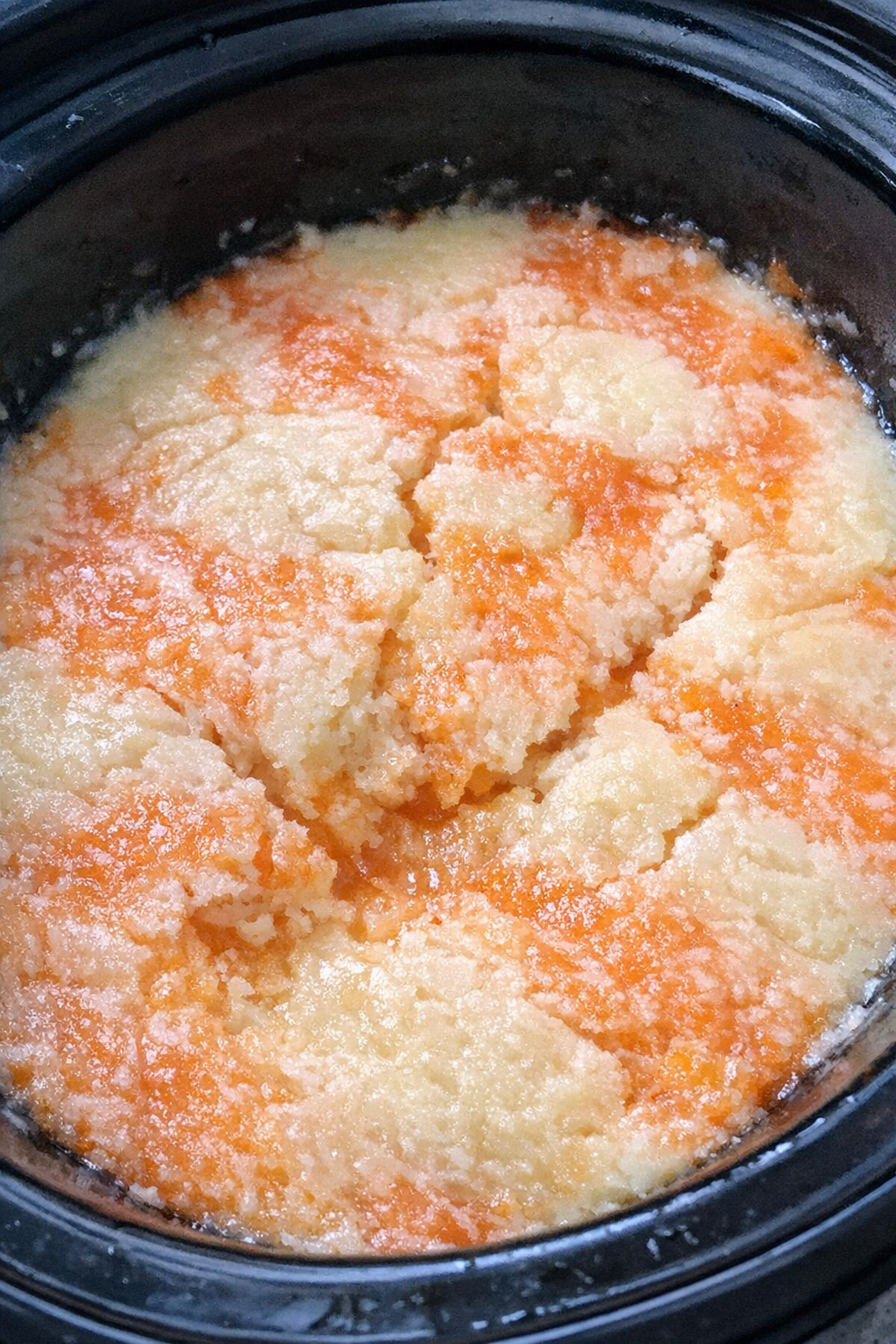 Slow cooker with creamy tangerine marbled dessert