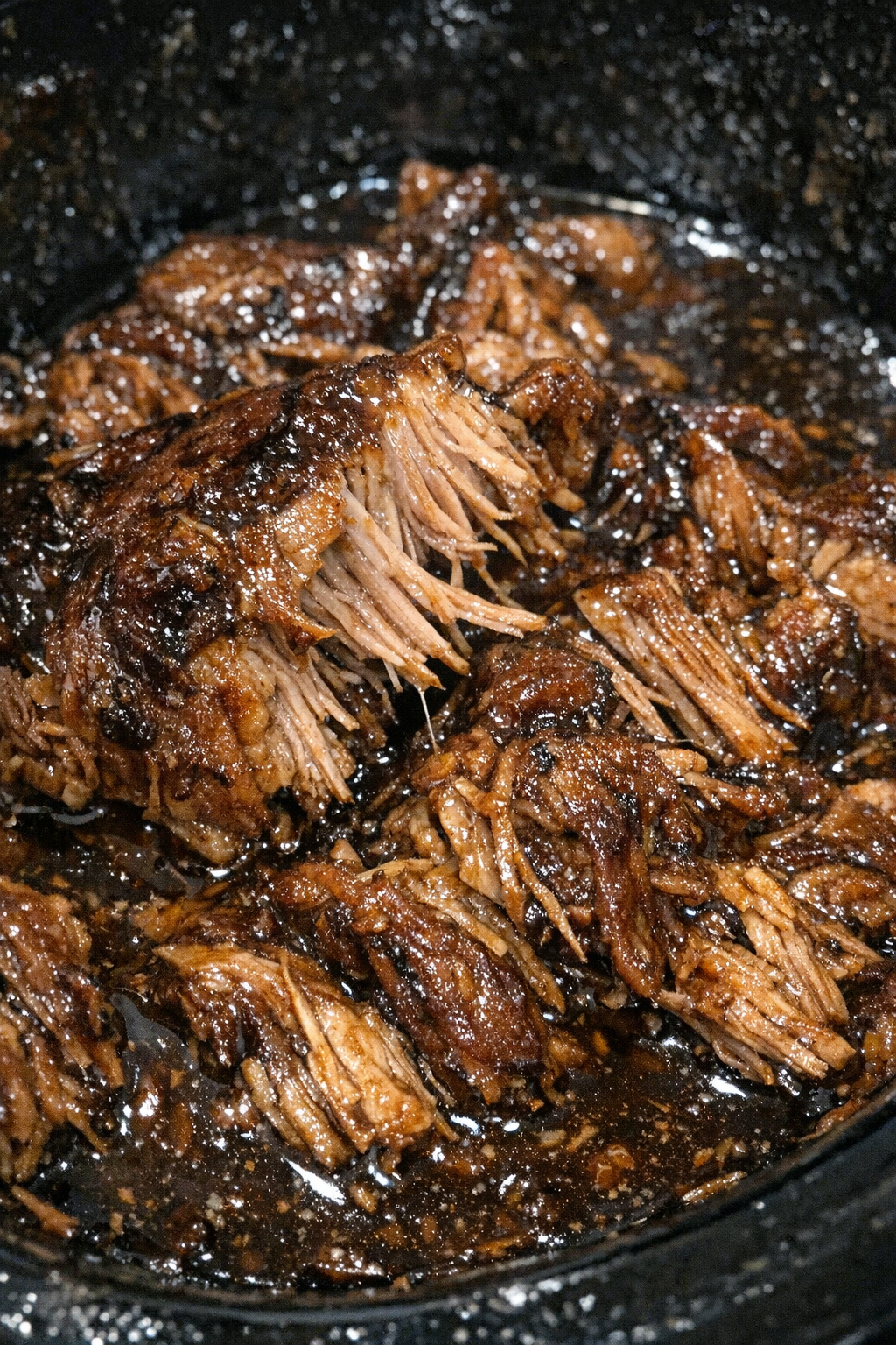 Slow cooker pork roast in dark glossy sauce