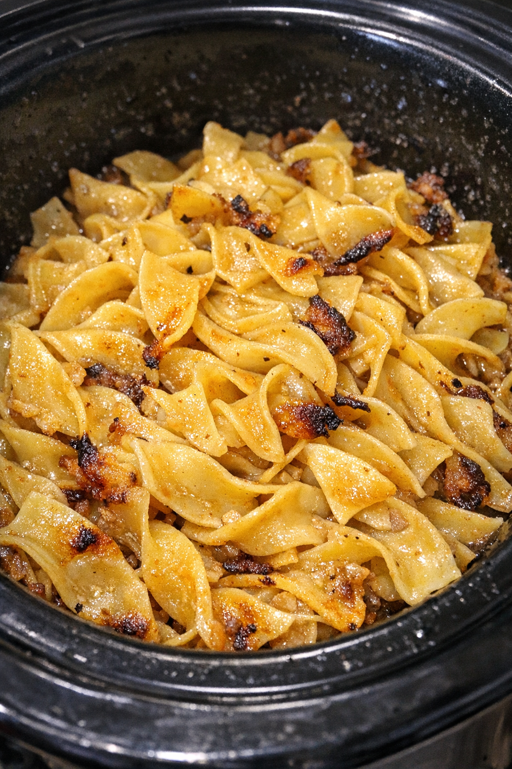 Slow cooker Amish schmaltz noodles in a black slow cooker