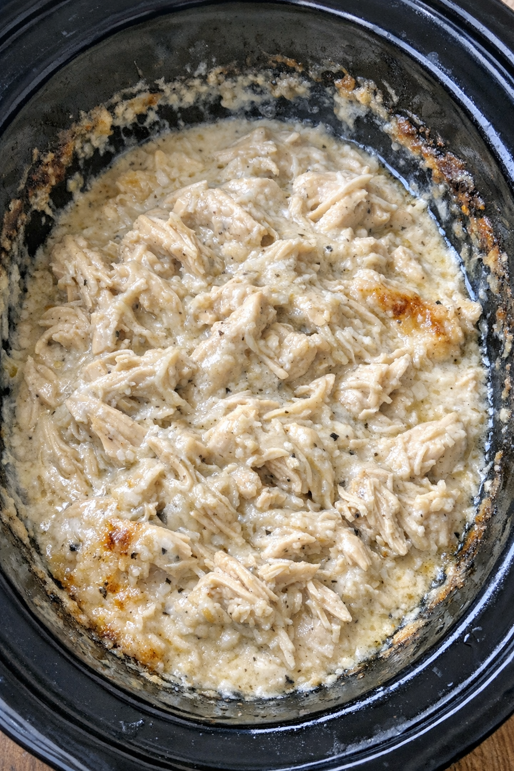 Slow cooker sour cream chicken in a black slow cooker