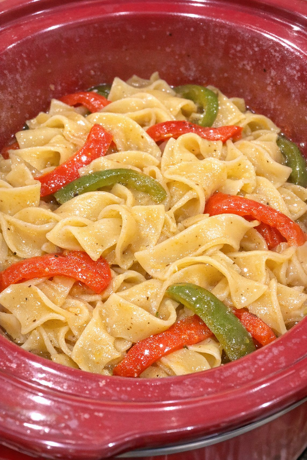 Slow cooker Amish bell pepper noodles in a red slow cooker
