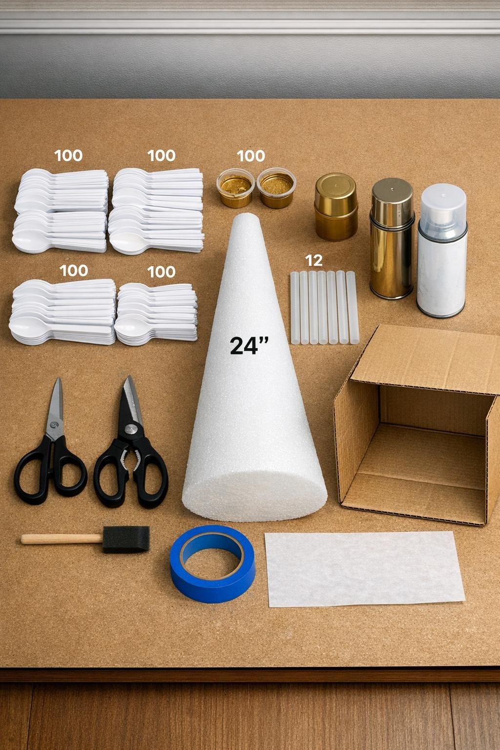 Materials for a gold spoon scale mantel tree laid out on a table