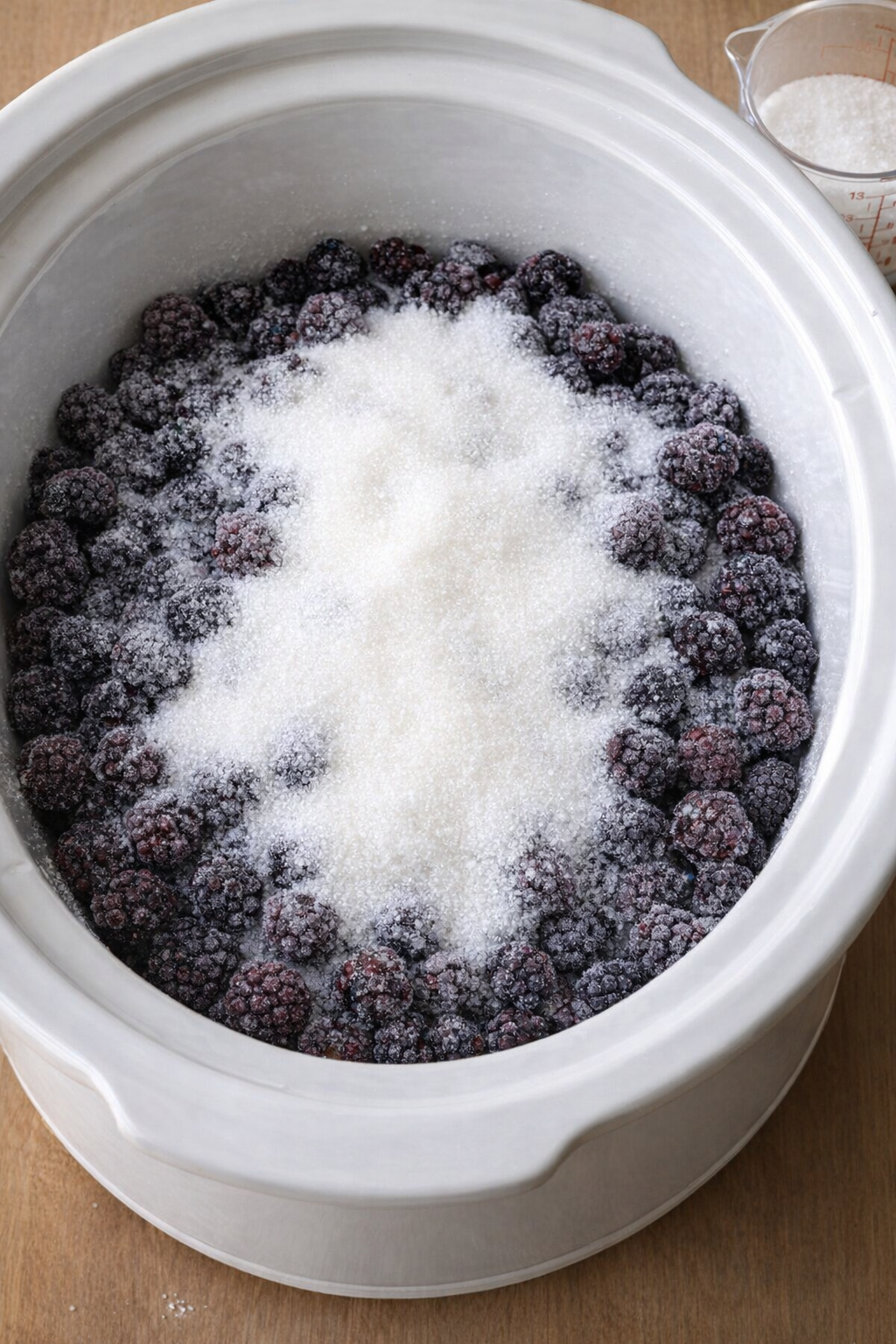 Frozen blackberries and sugar ready for the slow cooker