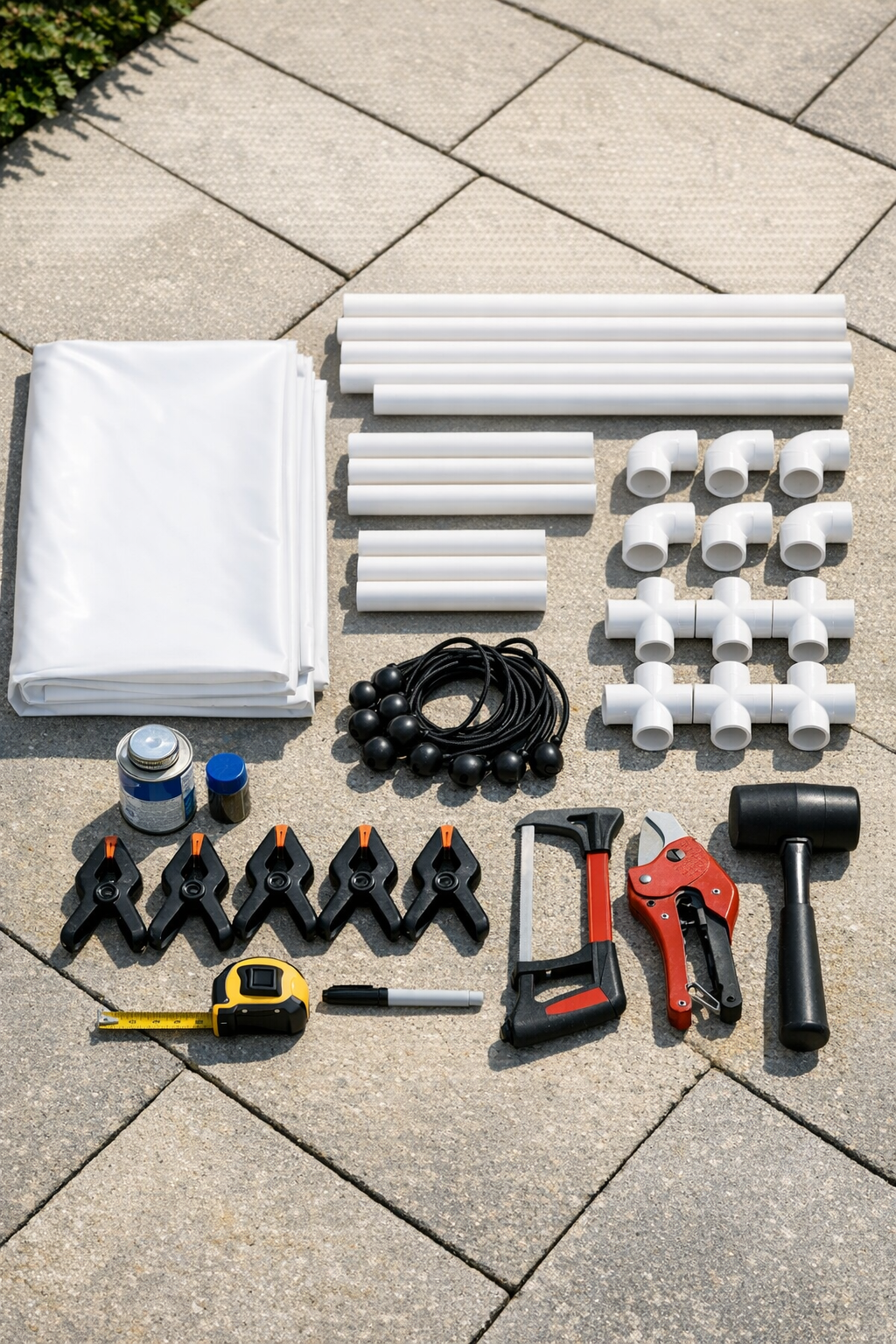 Materials for a PVC outdoor movie screen laid out on the ground