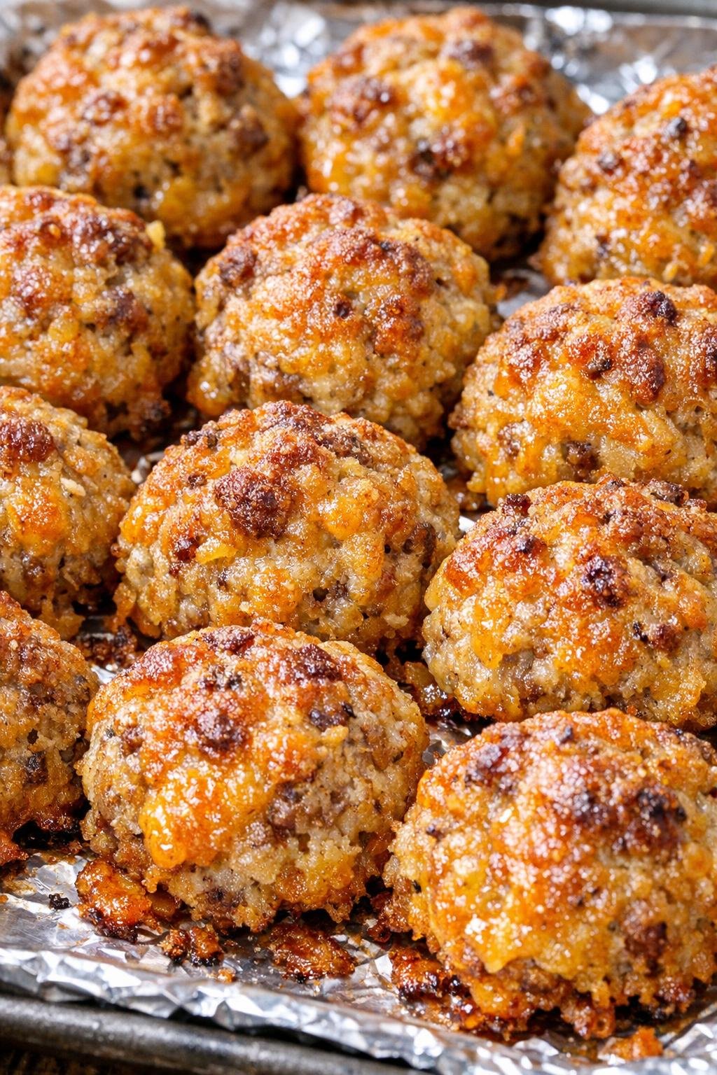 Southern 3-ingredient cheddar sausage bites on a foil-lined baking tray