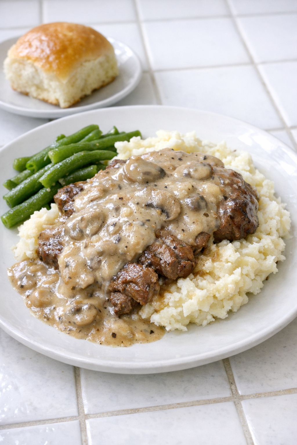 Finished Amish cream of mushroom beef plated with mashed potatoes