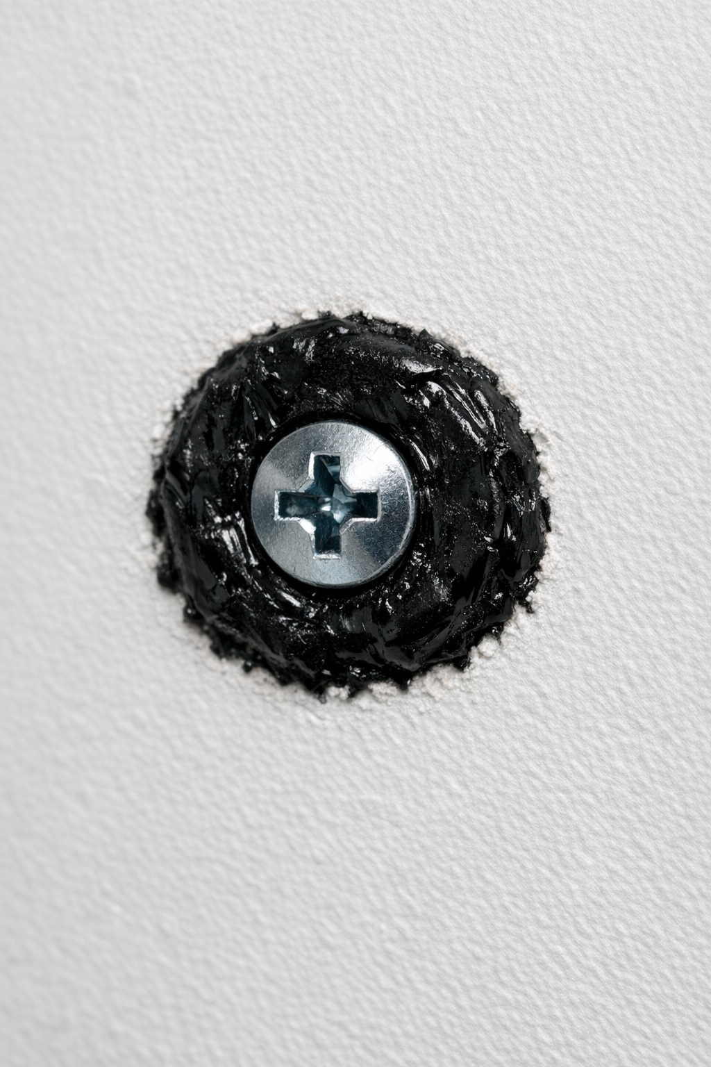 Finished DIY drywall anchor made from melted pocket comb plastic