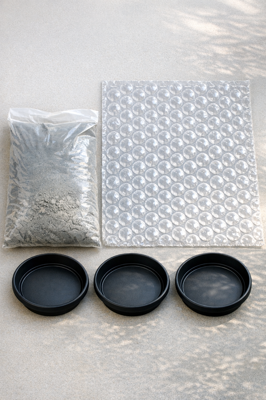 Materials laid out for making dimpled cement garden stones