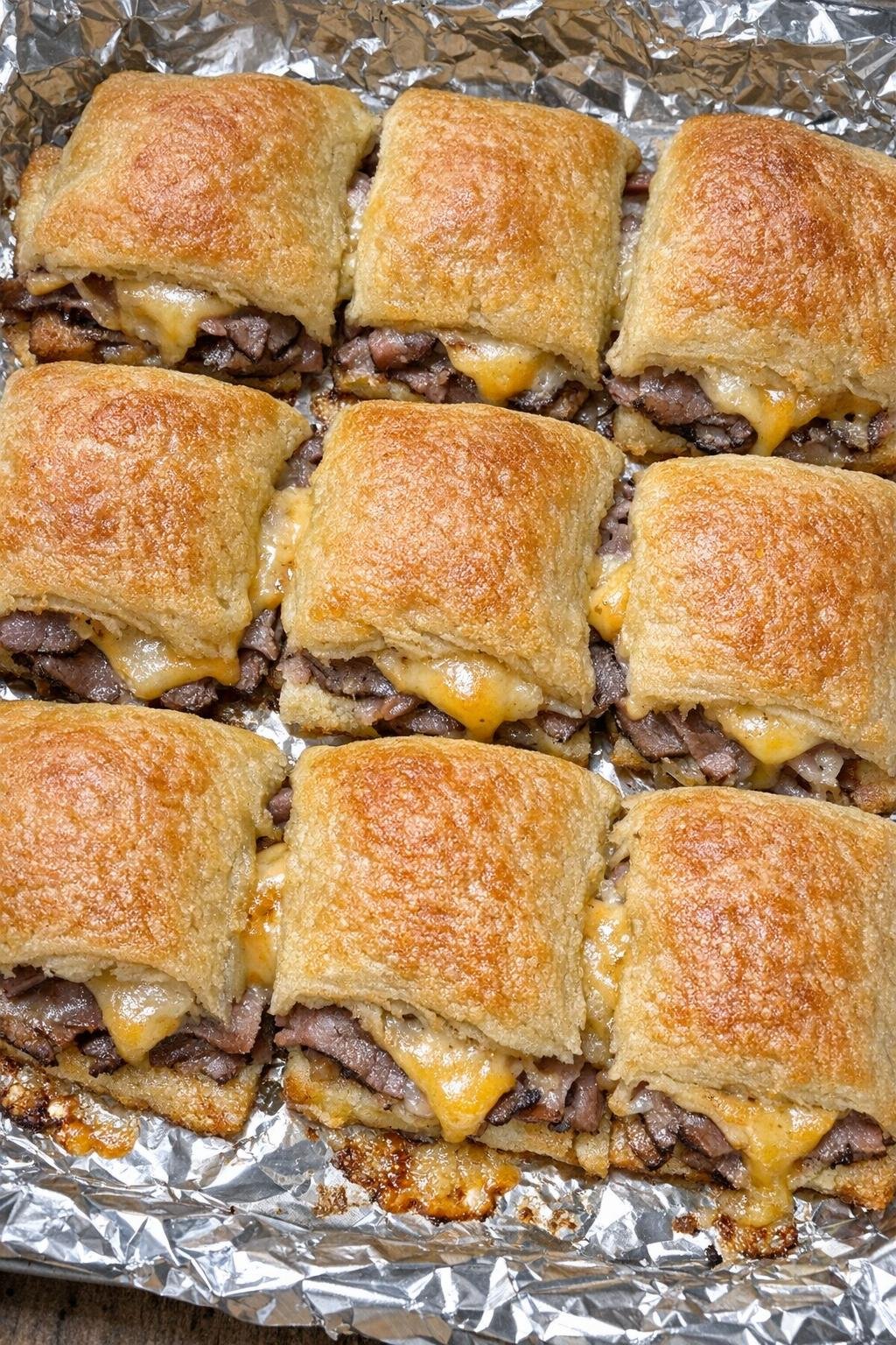 Flaky golden crescent dough squares stuffed with roast beef and melted American cheese