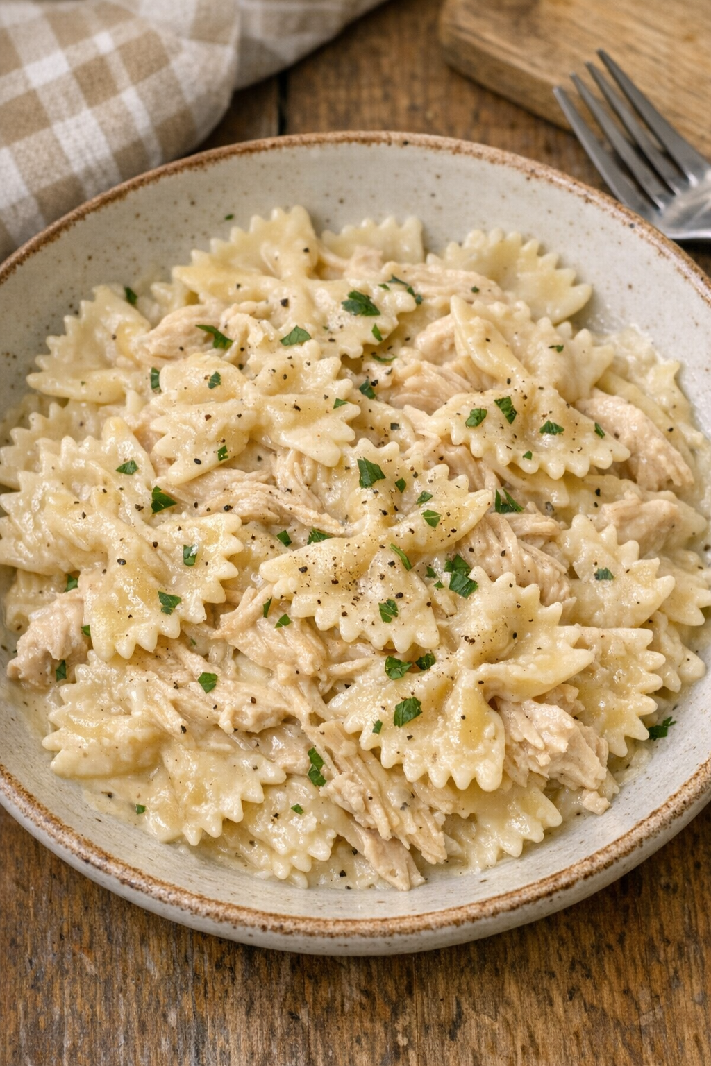 Finished creamy farfalle plated in a rustic bowl