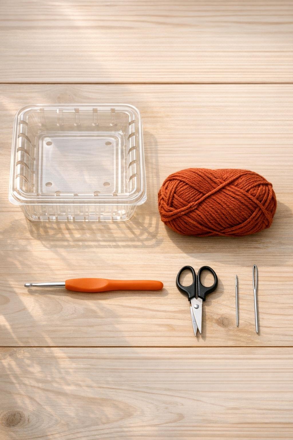 Materials for making a crocheted fruit bowl from a berry container