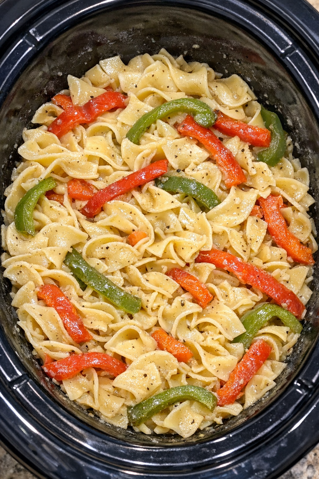 Slow cooker Amish bell pepper noodles in a black slow cooker