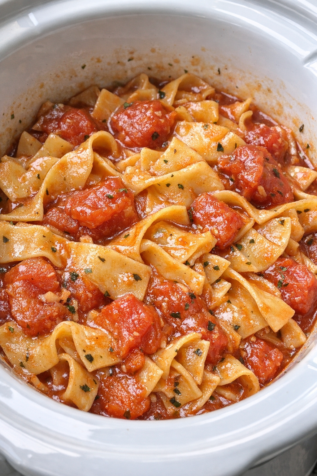 Slow cooker Amish tomato noodles in a white slow cooker