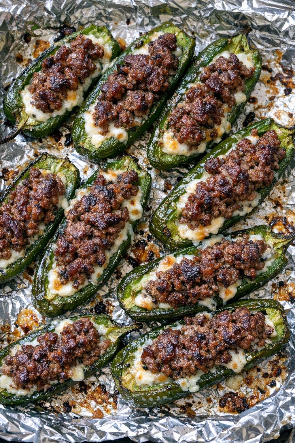 Finished beef stuffed jalapenos baked on a foil-lined tray