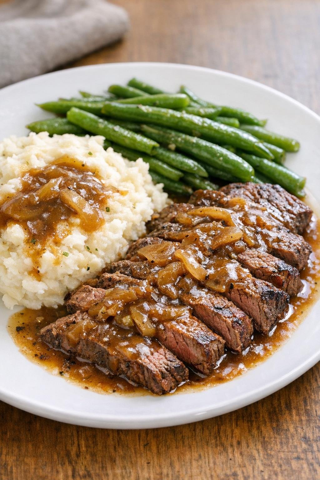 Finished slow cooker flat iron steak with gravy on a plate