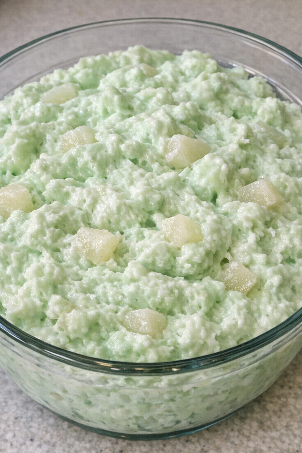 4-ingredient lime jello salad in a clear glass serving bowl