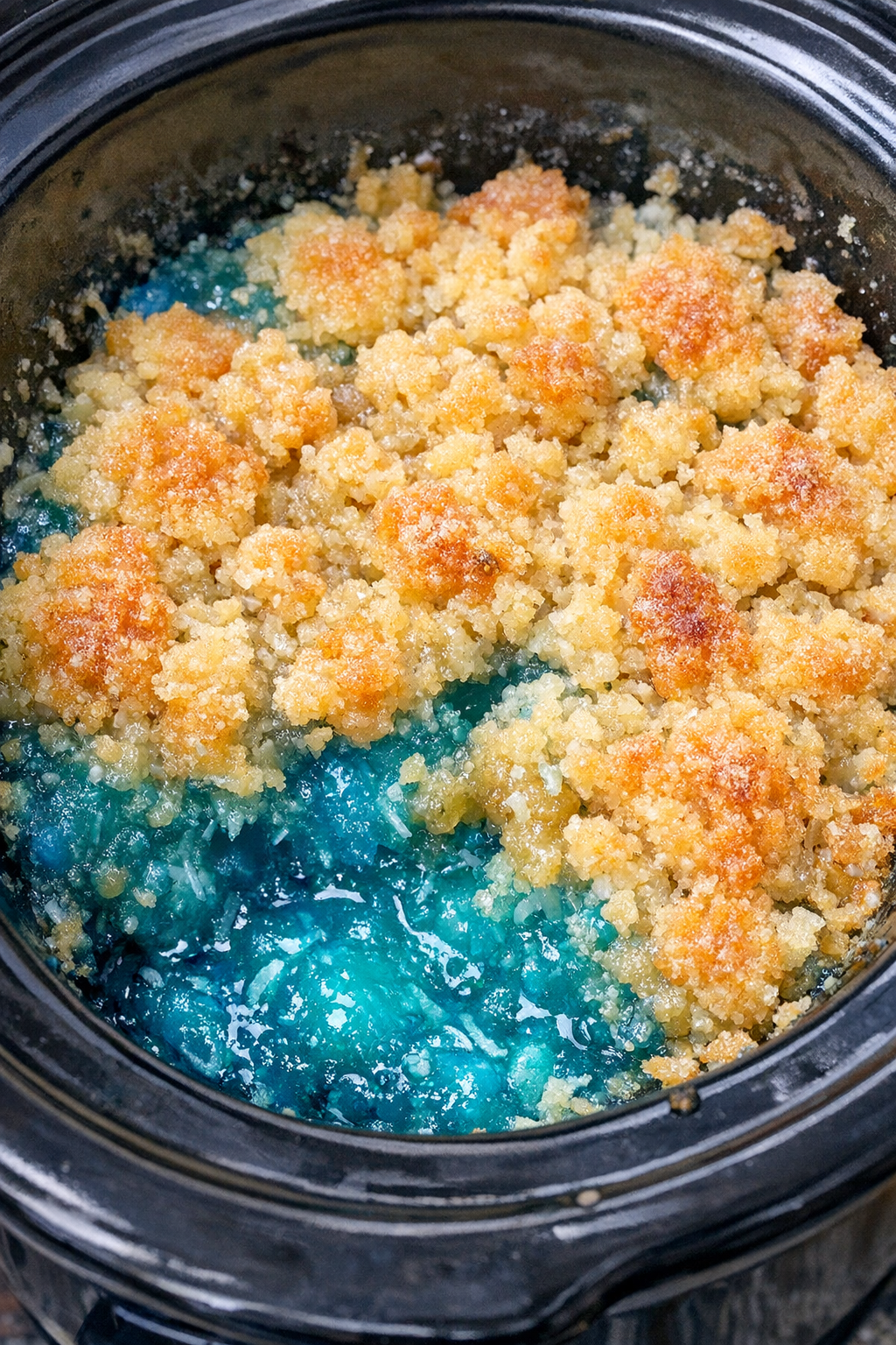 Finished ocean water dump cake in a black slow cooker
