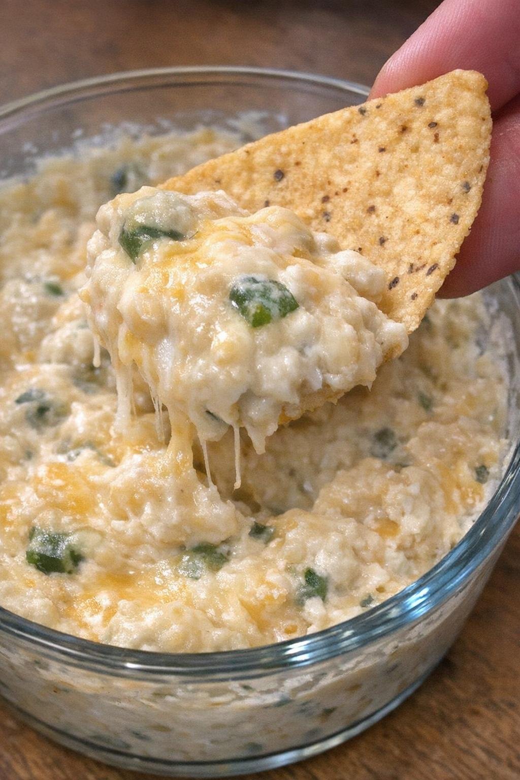 3-ingredient jalapeno merritt dip in a glass bowl with a corn chip scooping it