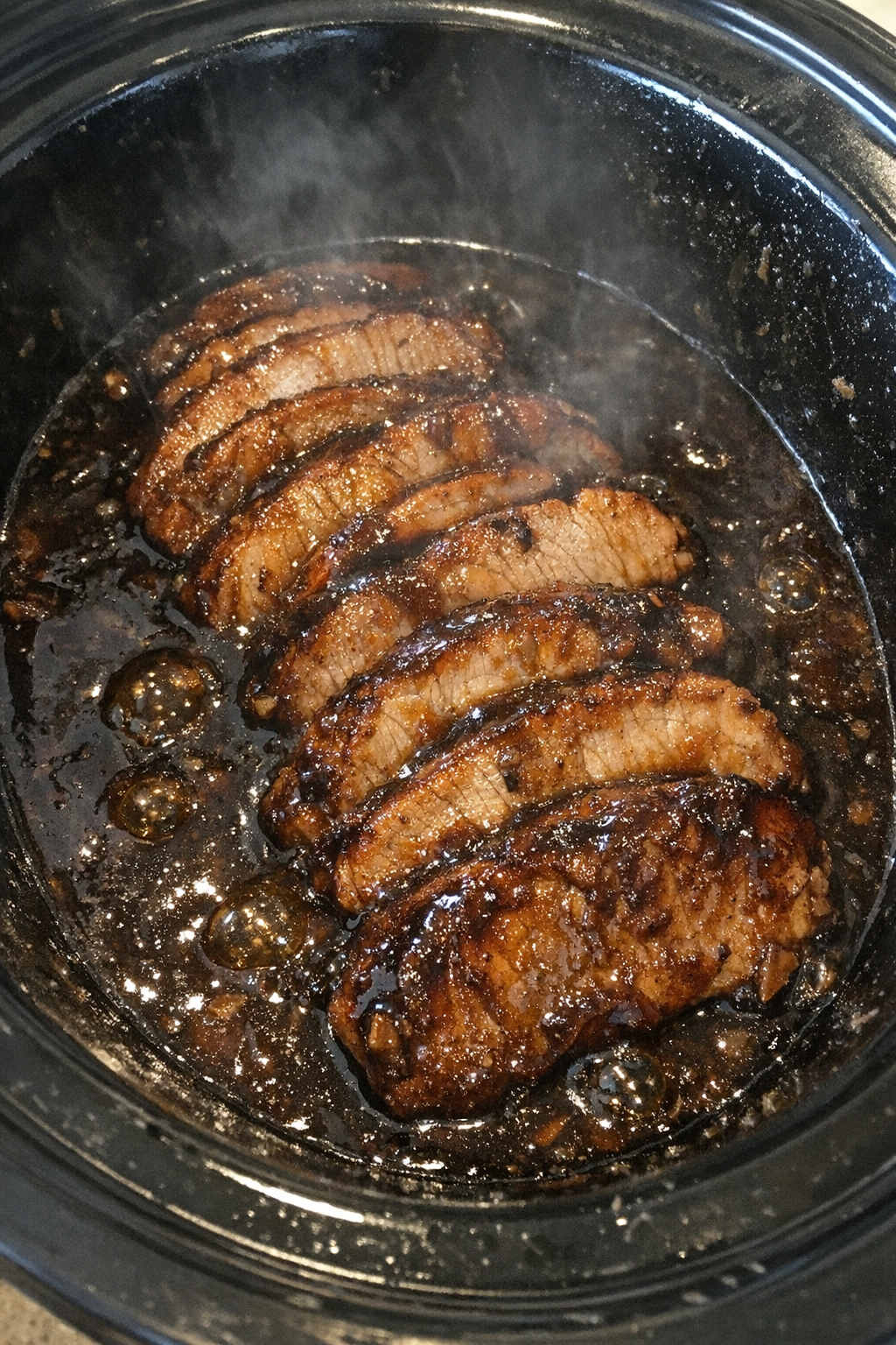 Slow cooker pork loin in dark glossy sauce