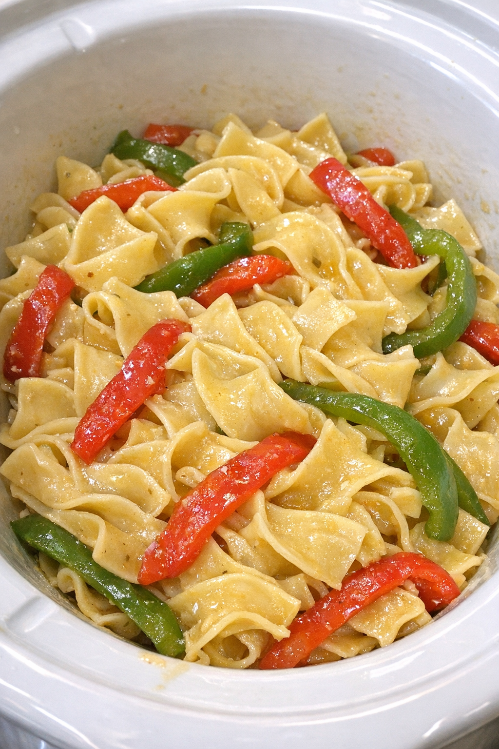 Slow cooker Amish bell pepper noodles in a white slow cooker