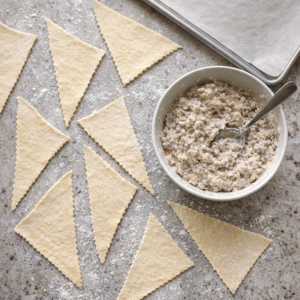 Crescent dough triangles and sausage filling ready for assembly