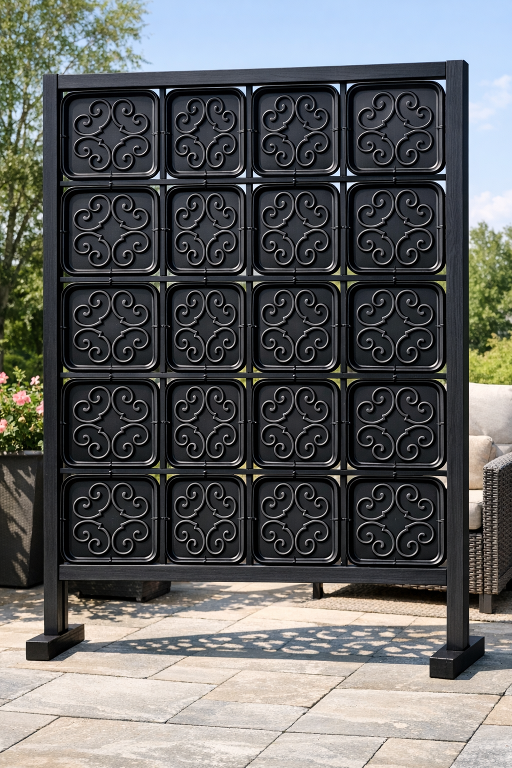 Finished faux wrought iron patio privacy screen made from painted trays and a wooden frame