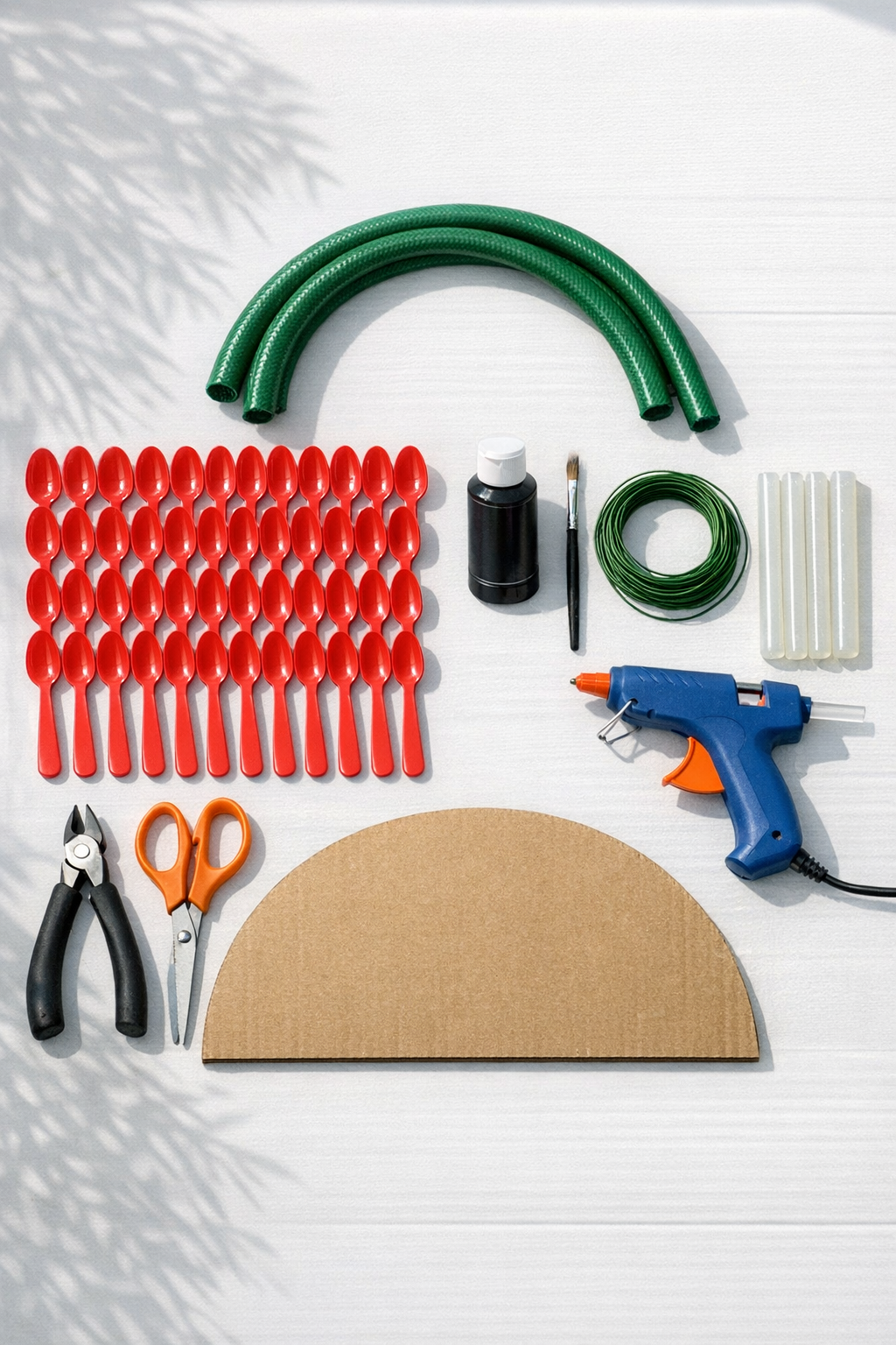 Materials for a watermelon slice door hanger laid out on a table