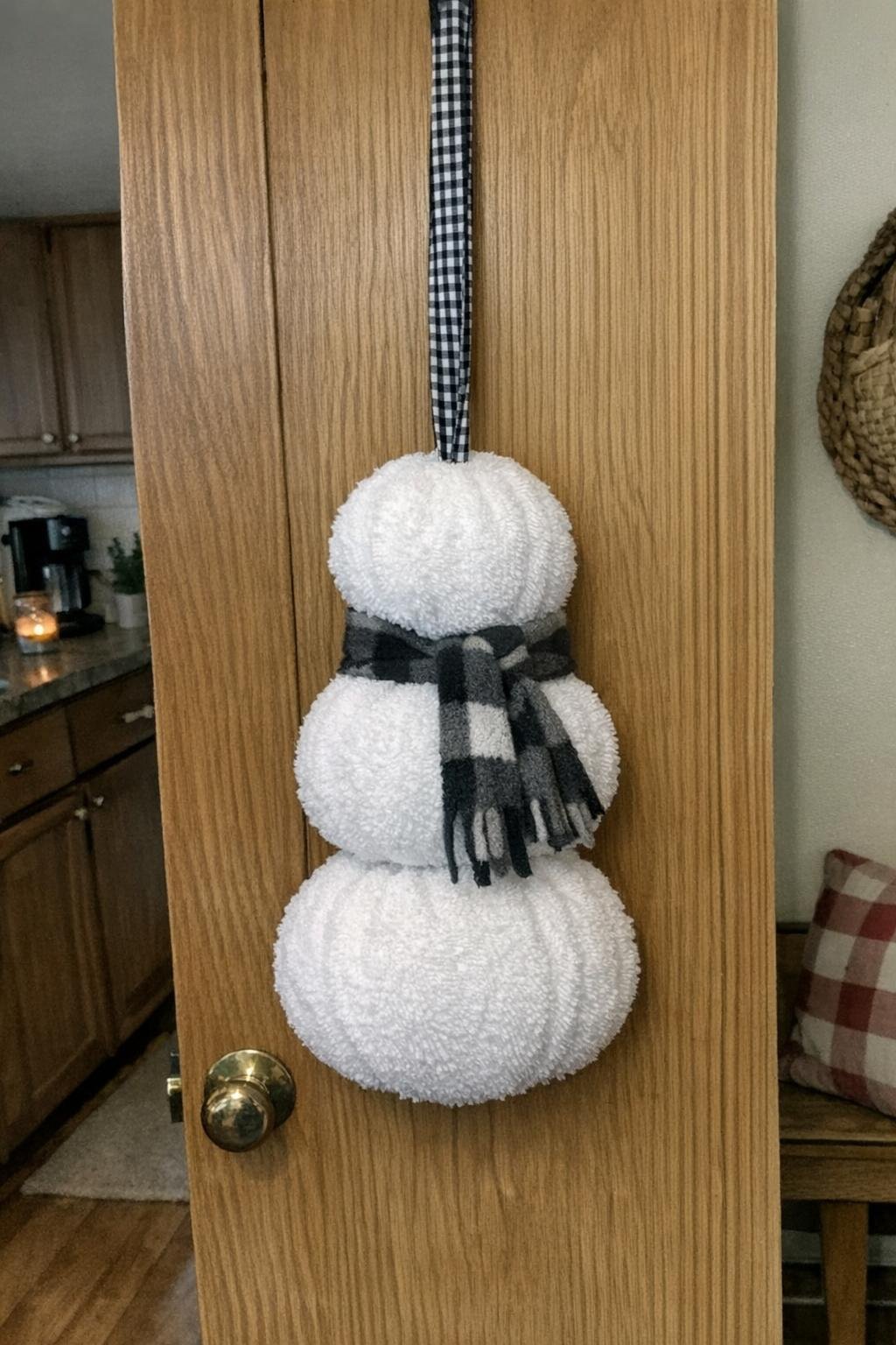 Snowman door hanger made from rolled white towels