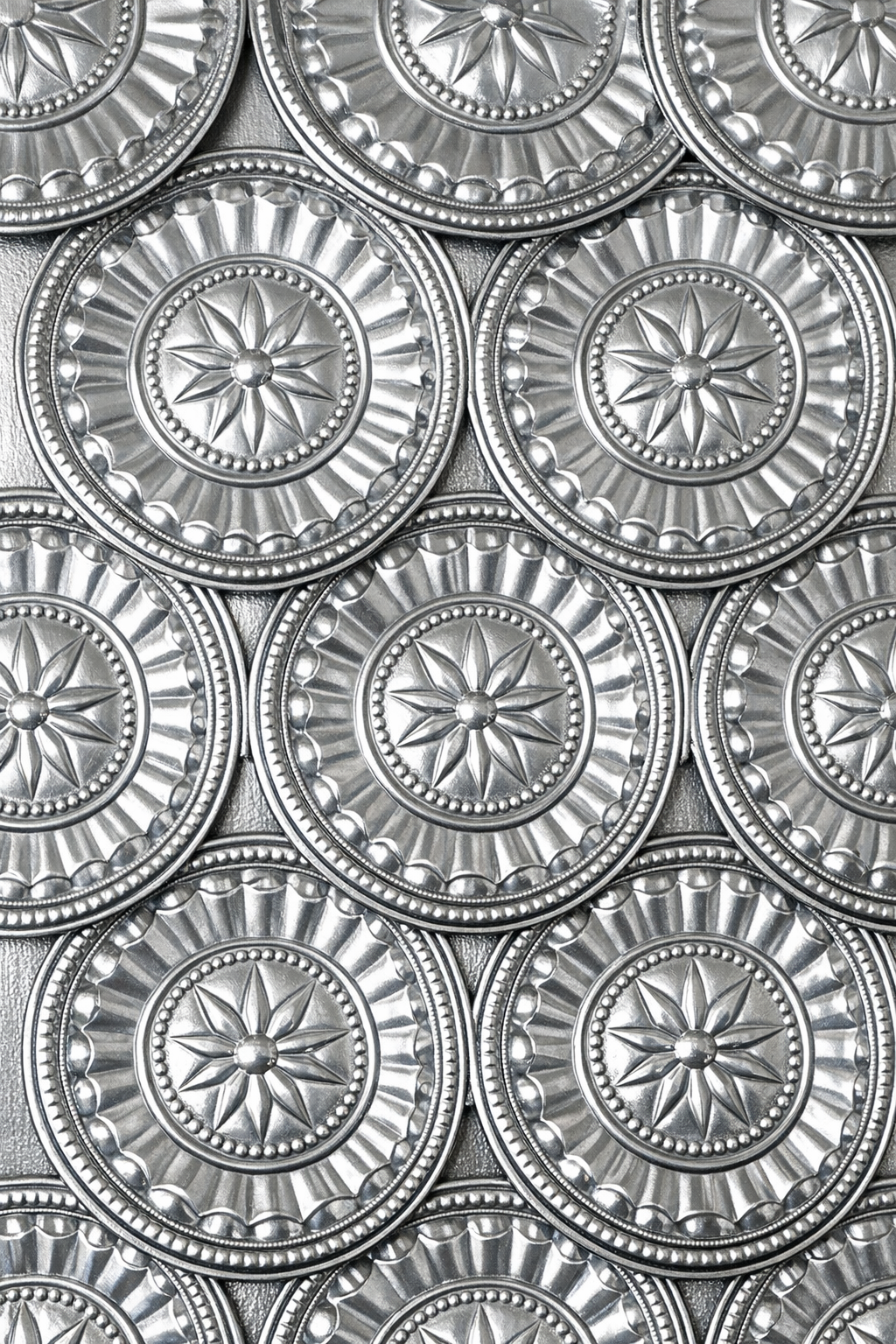 Finished faux stamped tin wall panels made from aluminum pie pans
