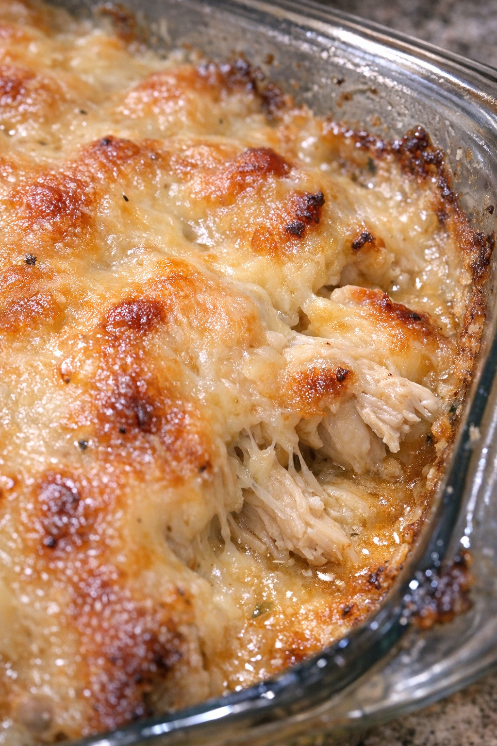 Cheesy roasted chicken casserole in a glass dish