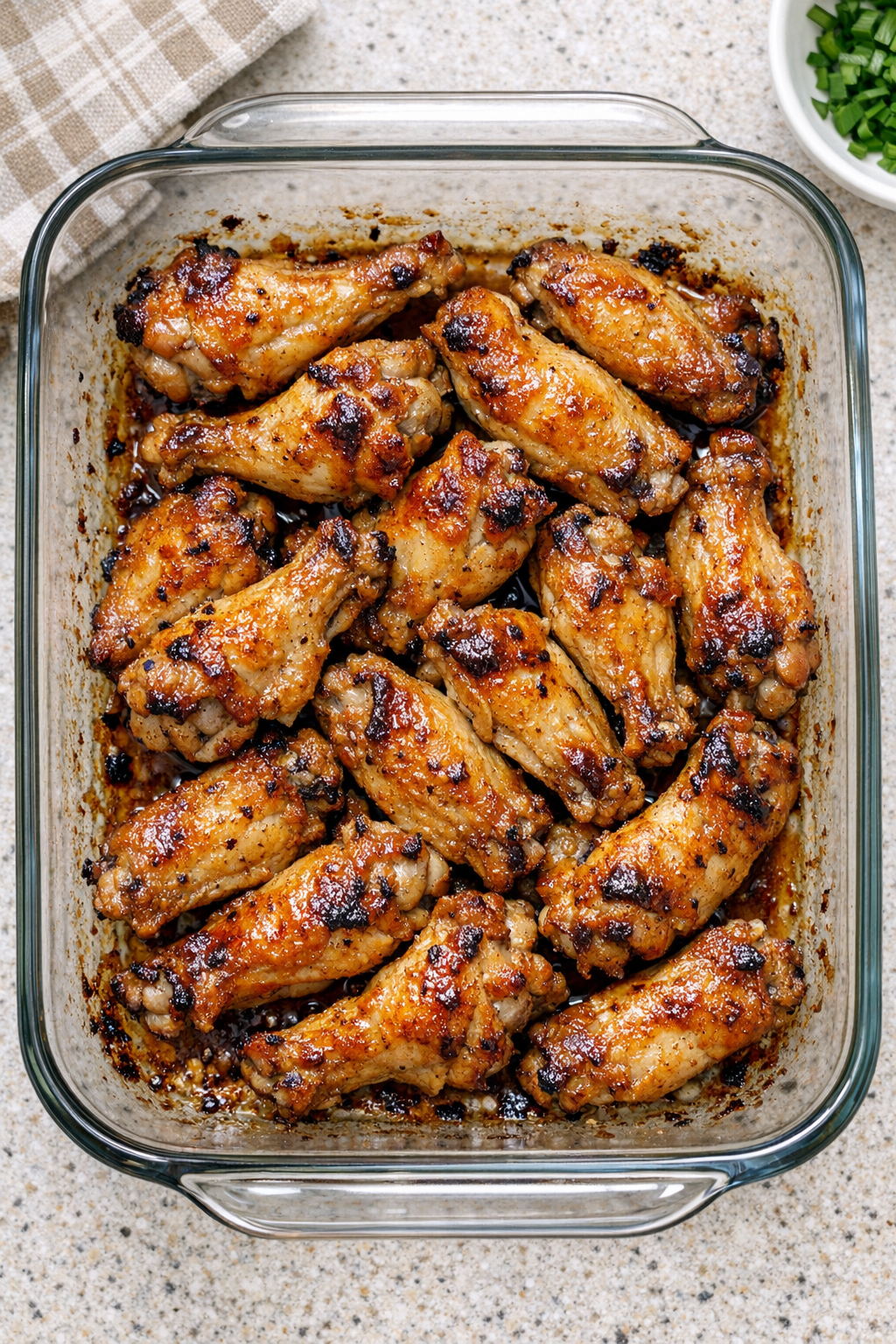 Baked chicken wings in a glass casserole dish