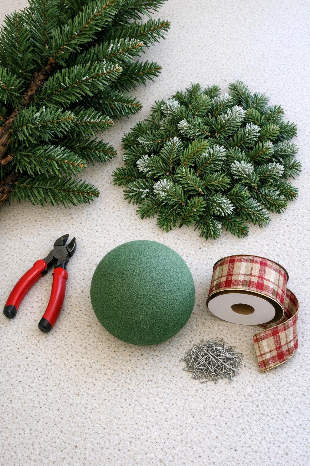 Materials for making an evergreen porch ball laid out on a counter