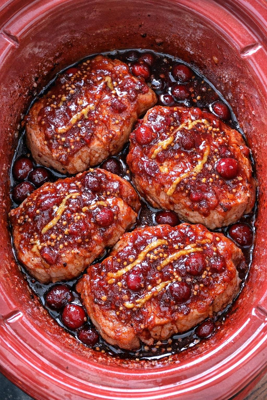Slow cooker cranberry mustard pork chops in a red slow cooker