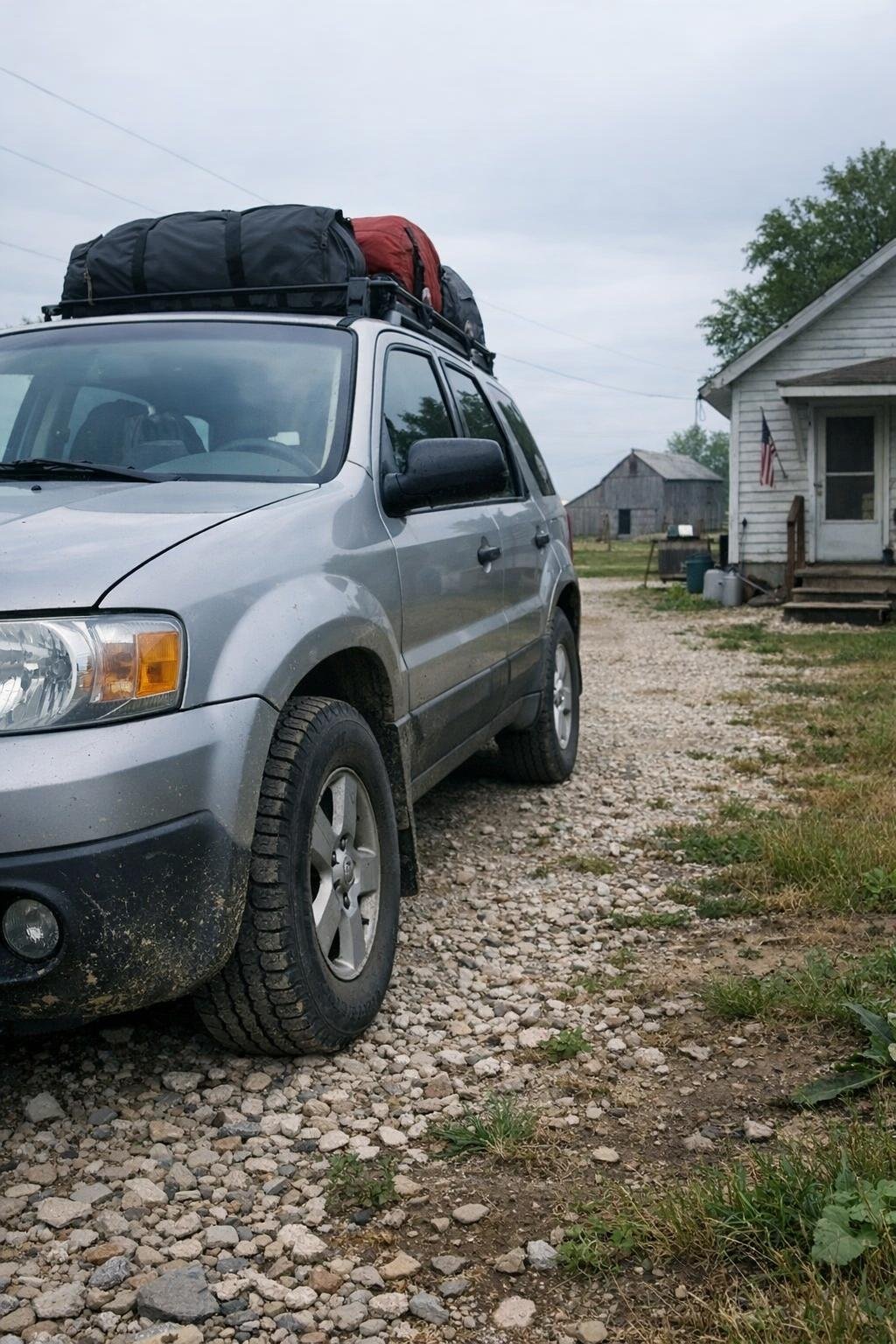 Rural driveway with a car ready to leave in overcast morning light