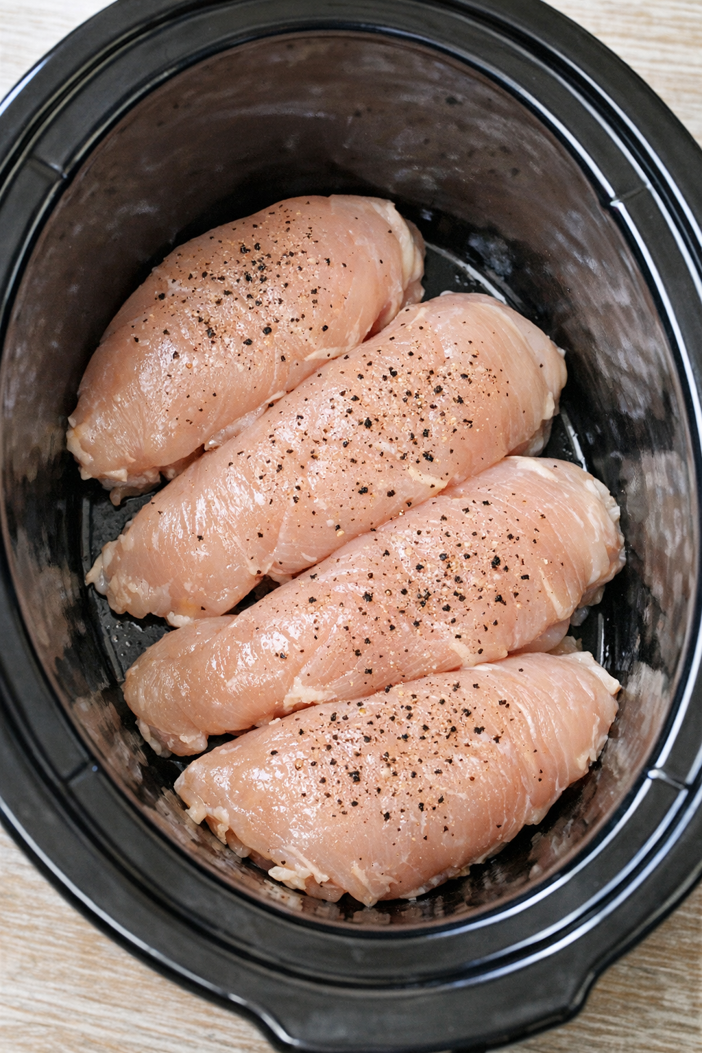 Chicken arranged in the slow cooker