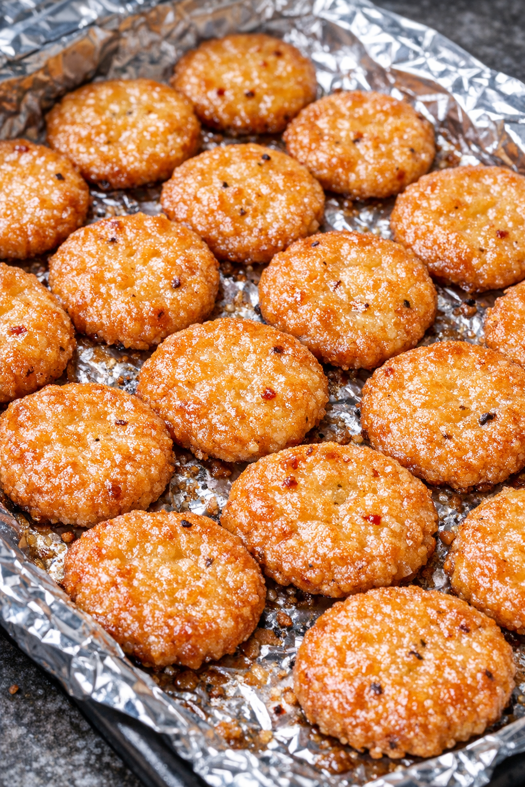 Southern 3-ingredient spicy cheese pennies on a foil-lined baking tray