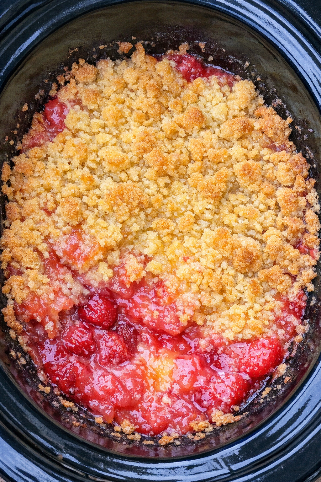 Slow cooker strawberry lemonade dump cake in a black slow cooker