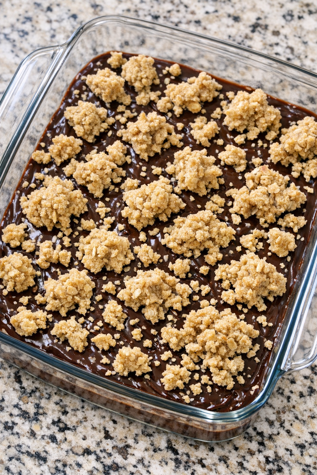 Crumbled oatmeal cookie dough topping over chocolate layer
