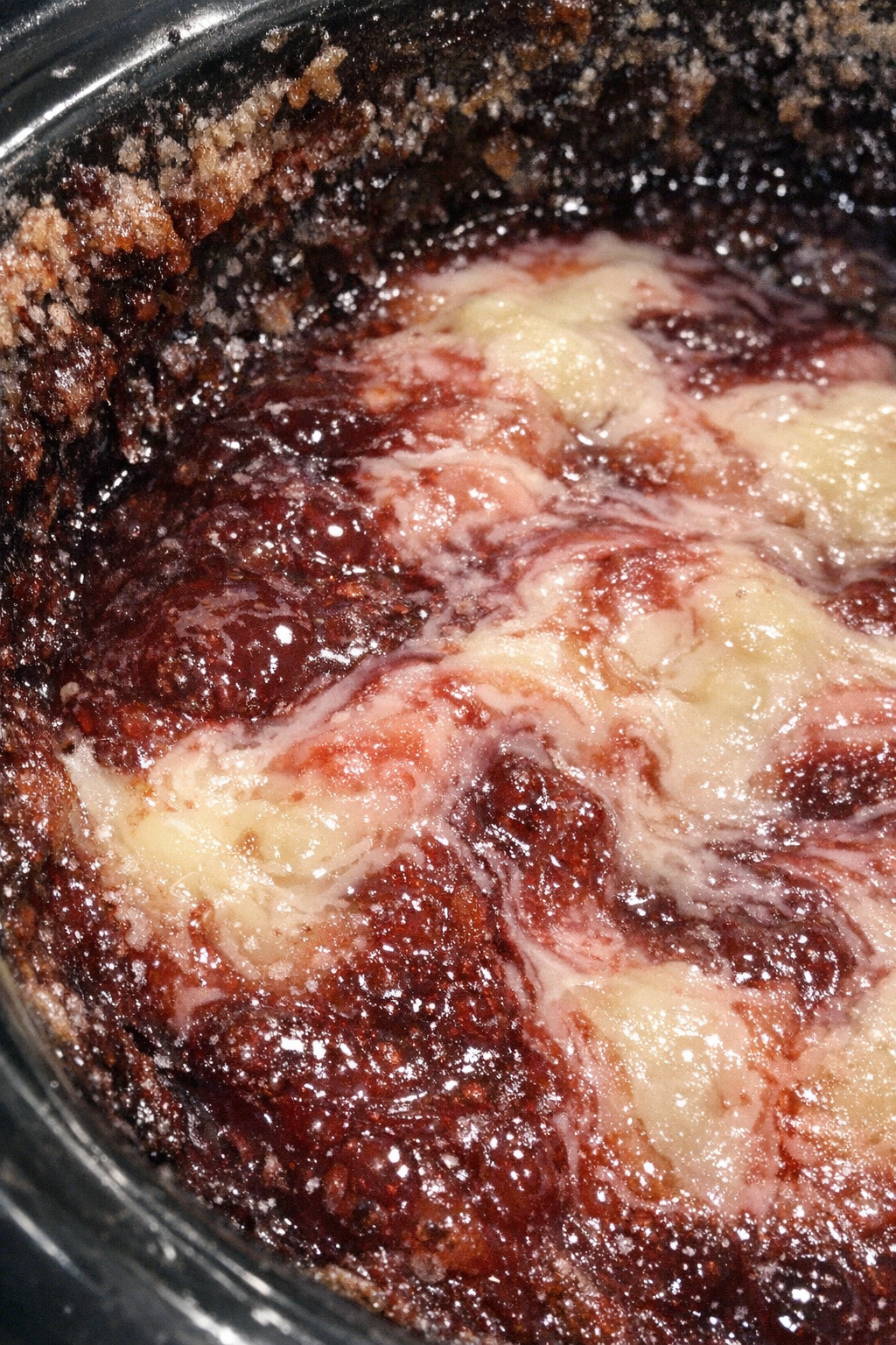 Crimson and ivory molten dessert swirling in a slow cooker