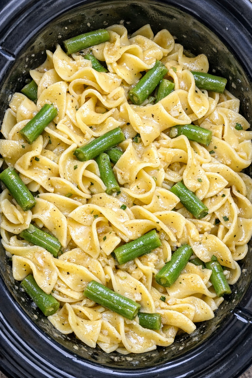 Slow cooker Amish green bean noodles in a black slow cooker